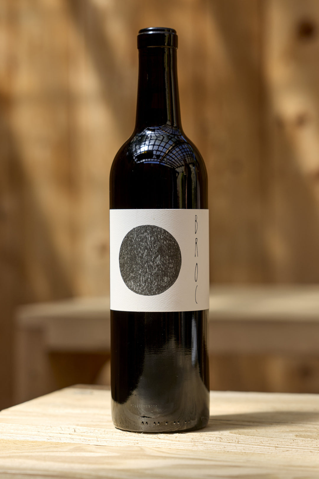A dark glass bottle of 2023 Massa Cabernet Sauvignon, featuring a white label with a large, textured black circle and vertical text.