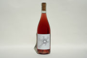 A 2024 OSunshine bottle of rosé wine from Broc Cellars, CCOF Certified Organic, stands upright with a cork top and a white label featuring a black geometric sunburst design against a plain light background.