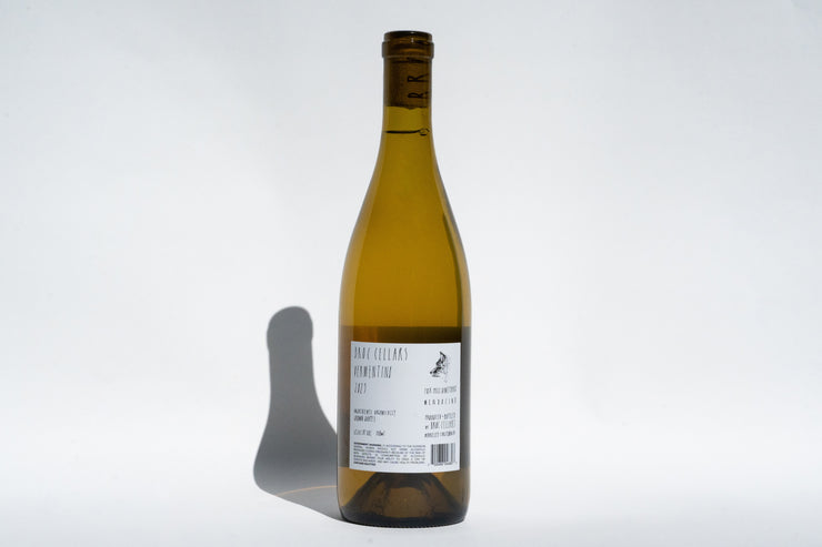 A tall, slender brown bottle of 2023 Fox Hill Vermentino from Broc Cellars is set against a plain light background. The white label features text and a small illustration, casting a shadow to the left. The intact cap hints at its Mendocino origins.