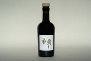 A dark green bottle with a wooden cork cap, exclusive for Club Only members, features a minimalist white label with two fern-like plants. Its the 2024 Olio Nuovo by Broc Cellars, ideal for those joining the club in November 2024.