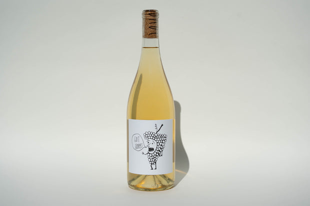 The 2024 Got Grapes White from Broc Cellars stands proudly with a cork, featuring a whimsical grape character on its label exclaiming Eat Grapes. Made from Orange Muscat, it shines against a plain, light-colored background.