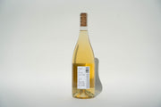 A clear glass bottle of 2024 Got Grapes White wine from Broc Cellars stands against a white background, highlighting its Orange Muscat variety. The label reflects the regions commitment to organic farming. Shadows on the right enhance its elegant silhouette.