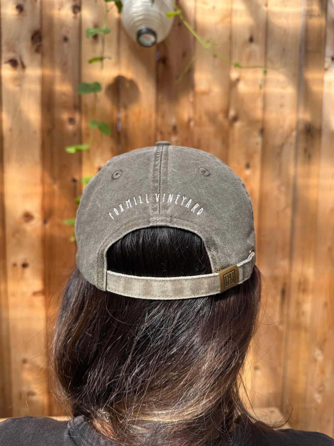 An olive green brushed cotton twill Fox Hill Field Hat by Broc Cellars featuring Foxmill Vineyard embroidered in white thread above the adjustable back strap.