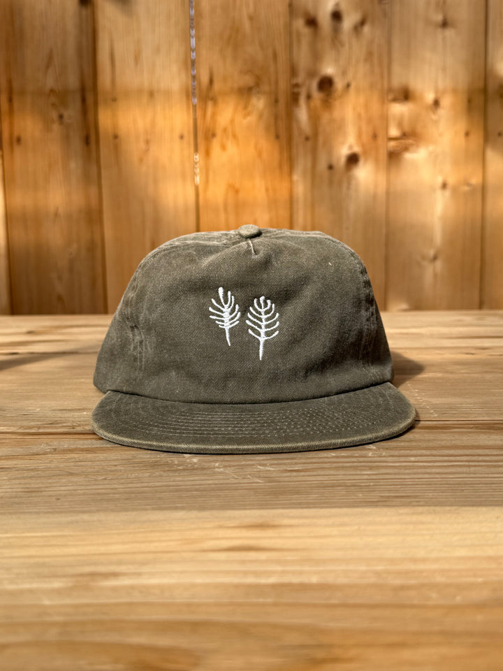 Olive green brushed cotton twill Fox Hill Field Hat with white embroidery of two stylized ferns on the front and an adjustable strap.
