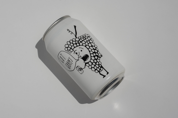 A Got Grapes Red Can by Broc Cellars, featuring a black illustration of grapes holding a drink and saying No worries on a white can, is photographed on a plain white surface. Coming soon.