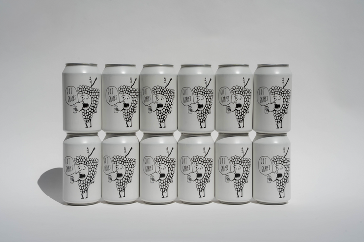 Twelve Got Grapes Red Cans from Broc Cellars are arranged in two rows of six. Each sleek can features a black and white abstract illustration with “CAN CRAFT” on the front, standing out against a plain white background—coming soon.