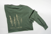 The Fox Hill Organic Long Sleeve Shirt by Broc Cellars is a green unisex tee, made in the USA. It features light yellow tall flower artwork and "Fox Hill Vineyard" text on the back for a comfortable, stylish fit.
