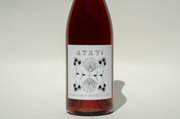 A bottle of 2024 Ayay! wine from Broc Cellars with a white label featuring AYAY! in bold above a symmetrical black and white botanical illustration, set against a plain, light background.