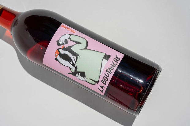 A bottle of 2024 La Boutanche by Broc Cellars, labeled with an illustrated badger in a green shirt raising its fists on a pink background—made from Sangiovese grapes sourced from the renowned Fox Hill Vineyard.
