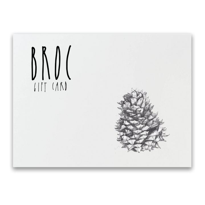 The Broc Gift Card from Broc Cellars features BROC in stylized black letters on a white background, labeled as GIFT CARD, and adorned with an elegant black and white pencil drawing of a pine cone, making it perfect for online shopping.
